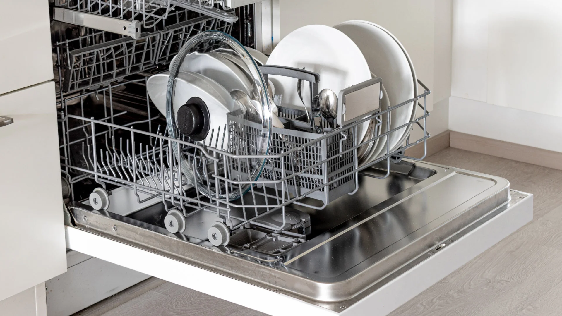 Dishwasher top rack loaded with glasses and bowls